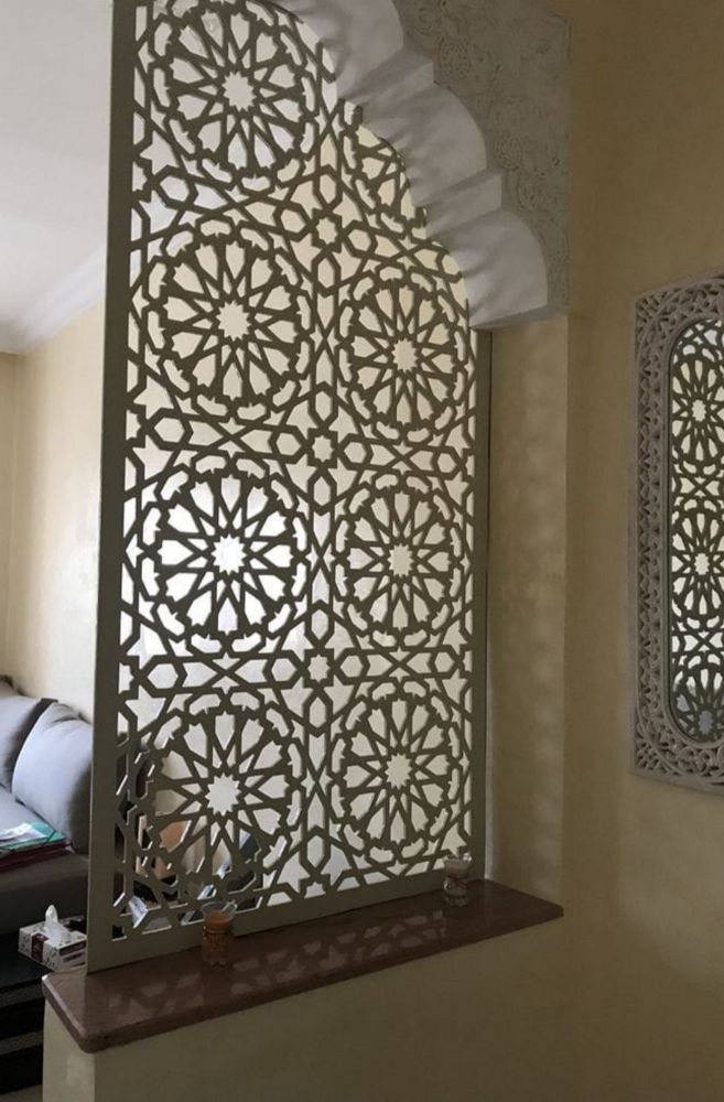 Laser cut acrylic sheet panel with LED backlighting showing warm orange glow through intricate devotional patterns